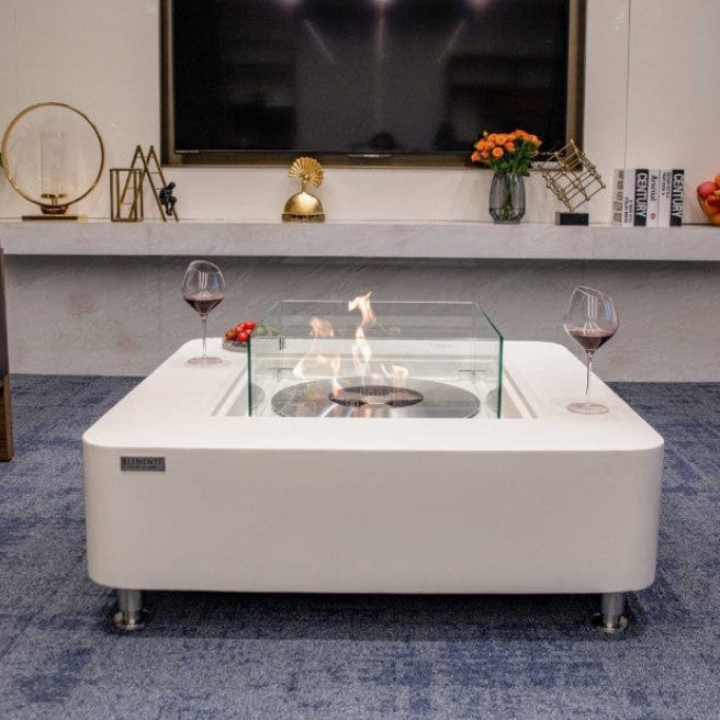 Modern living room with a Cream White fire pit table and Elementi branding.