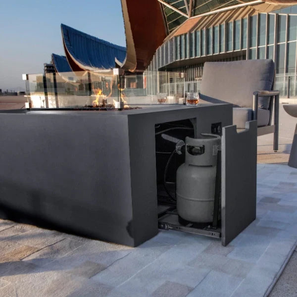 Outdoor Elementi Rocky fire pit with gas tank compartment on a rooftop patio