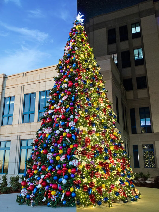 Decorated Christmas tree with colorful ornaments in front of a building