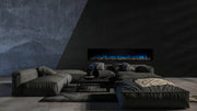 Landscape Pro Slim 80 inch electric fireplace with blue flames on a black wall behind a gray sectional, Modern Flames
