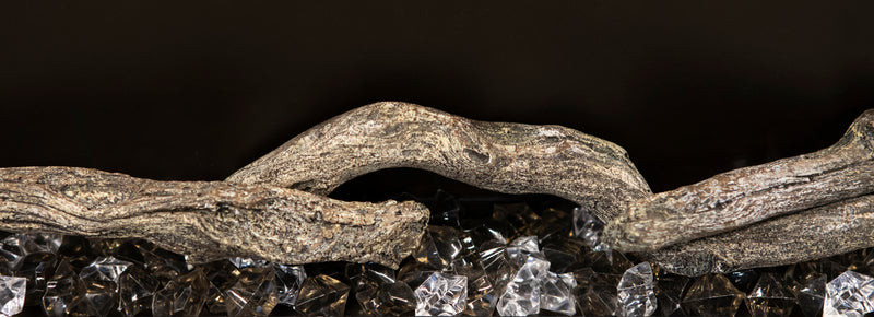 Close-up of Modern Flames Landscape Pro Slim driftwood log over acrylic crystals