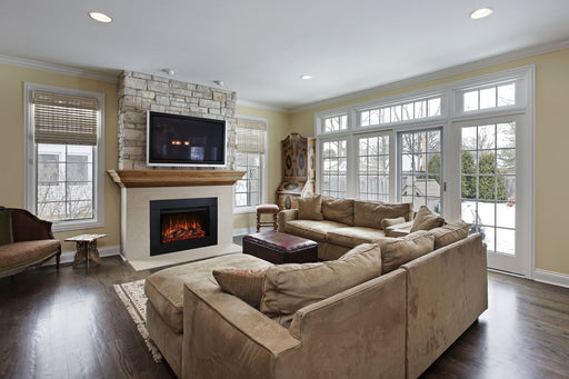 Redstone 36 electric fireplace built into a stone wall under a mounted TV and wood mantel