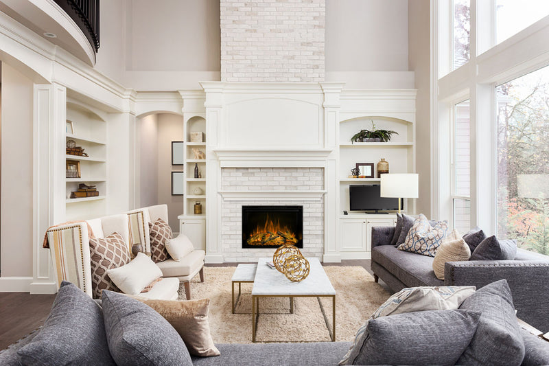 Modern Flames Redstone 36 with orange flames inside a white brick fireplace in a bright living room