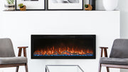 Modern Flames Spectrum Slimline 50 electric fireplace with blue embers and driftwood logs between two gray armchairs