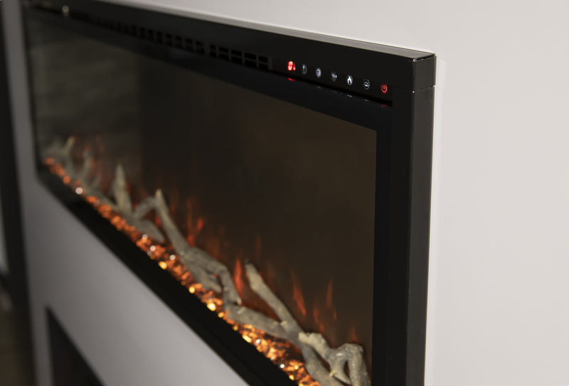 Angled view of the Modern Flames Spectrum Slimline trim, top touch controls and driftwood logs over orange embers