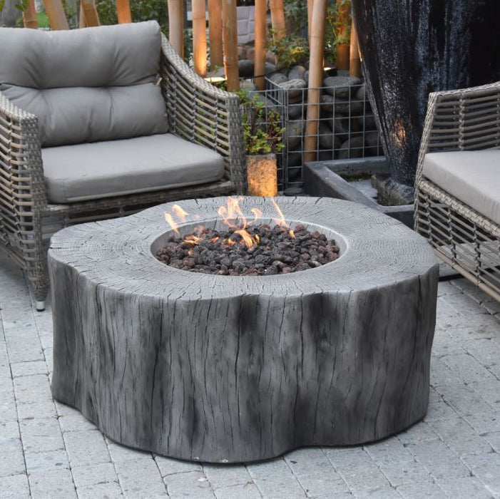 Outdoor patio setting with a fire pit table and wicker chairs.