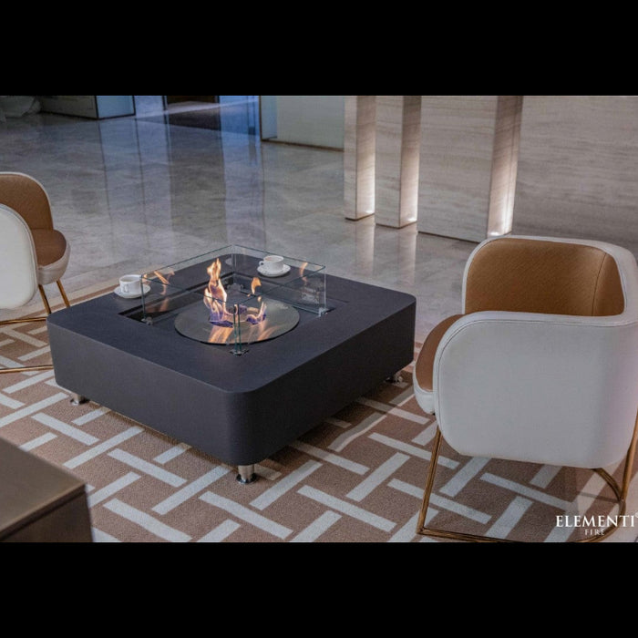 Modern Elementi ethanol fire pit table with chairs in a stylish room