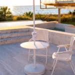 Outdoor patio with table and chairs on a sunny day