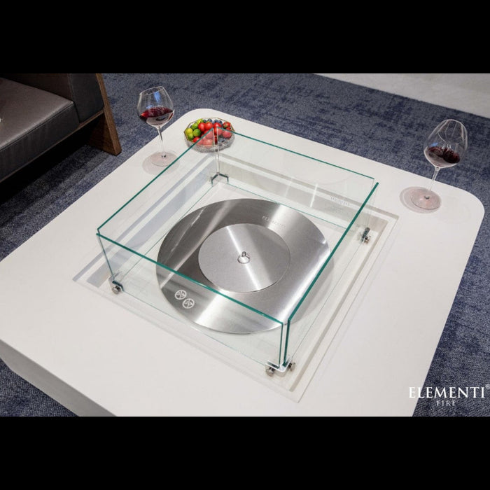 Modern glass coffee table with metal burner and Elementi logo